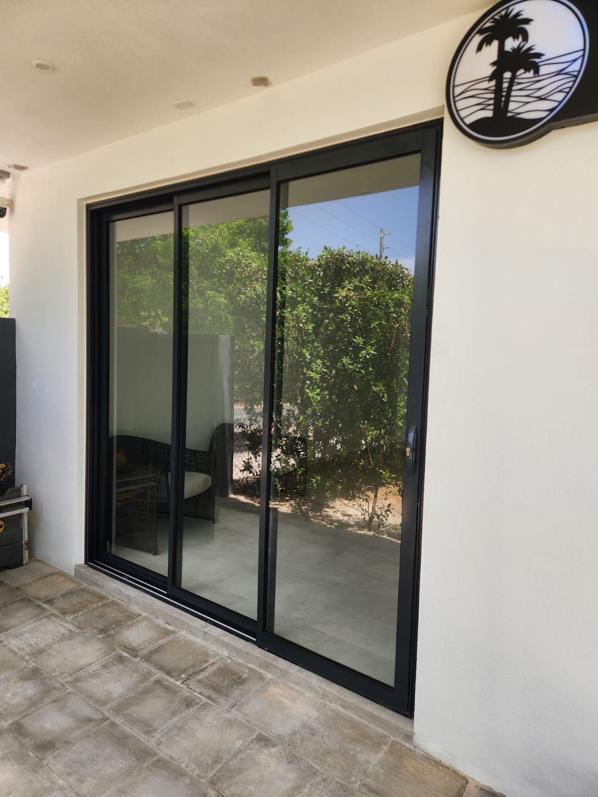 Black aluminium sliding patio door on a modern villa terrace in Anguilla