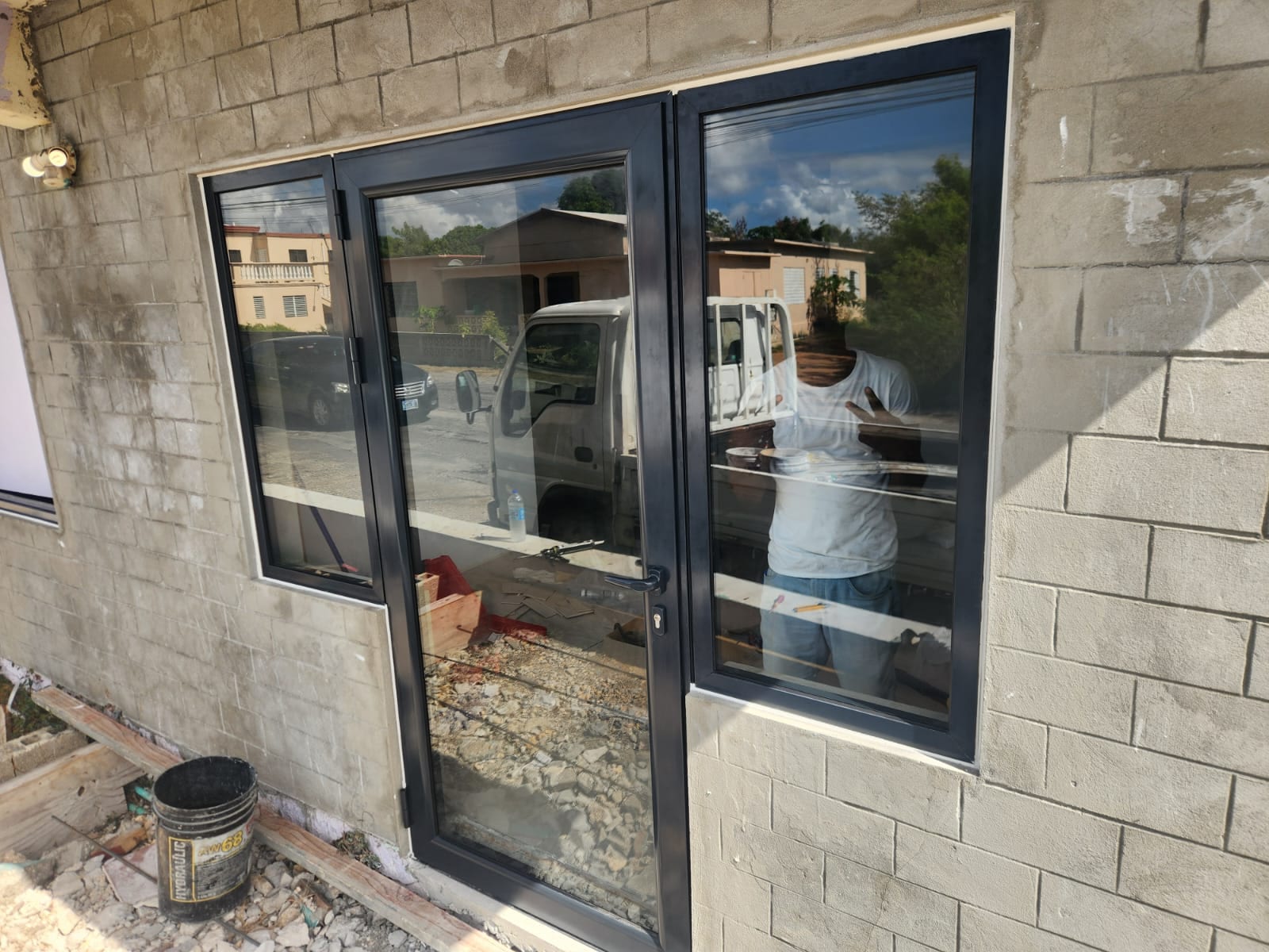 Completed charcoal aluminium entry door with sidelights on a building in Anguilla