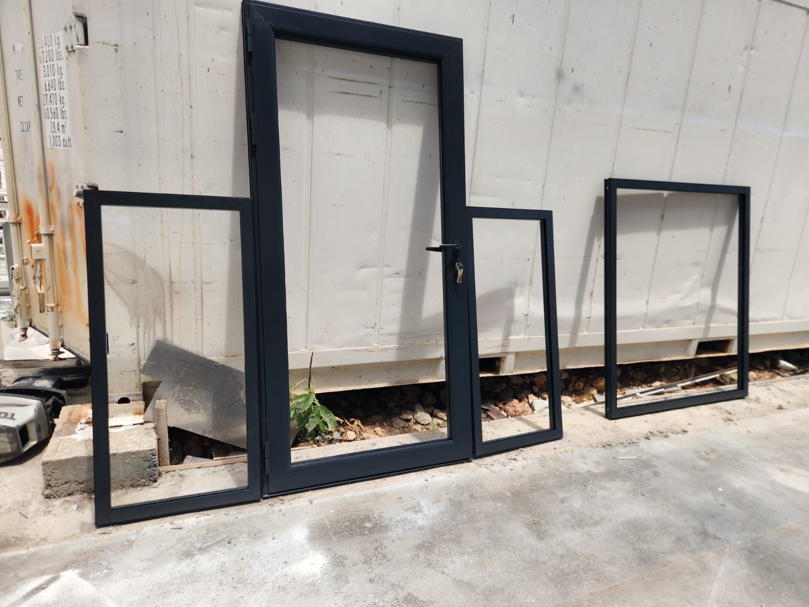 Charcoal aluminium door and window frames ready for installation at a site in Anguilla