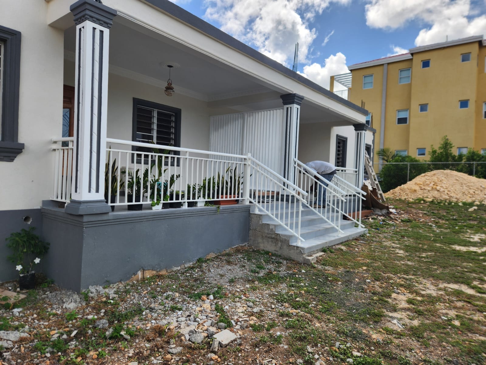 White aluminium porch railings and a matching stair handrail at a house in Anguilla