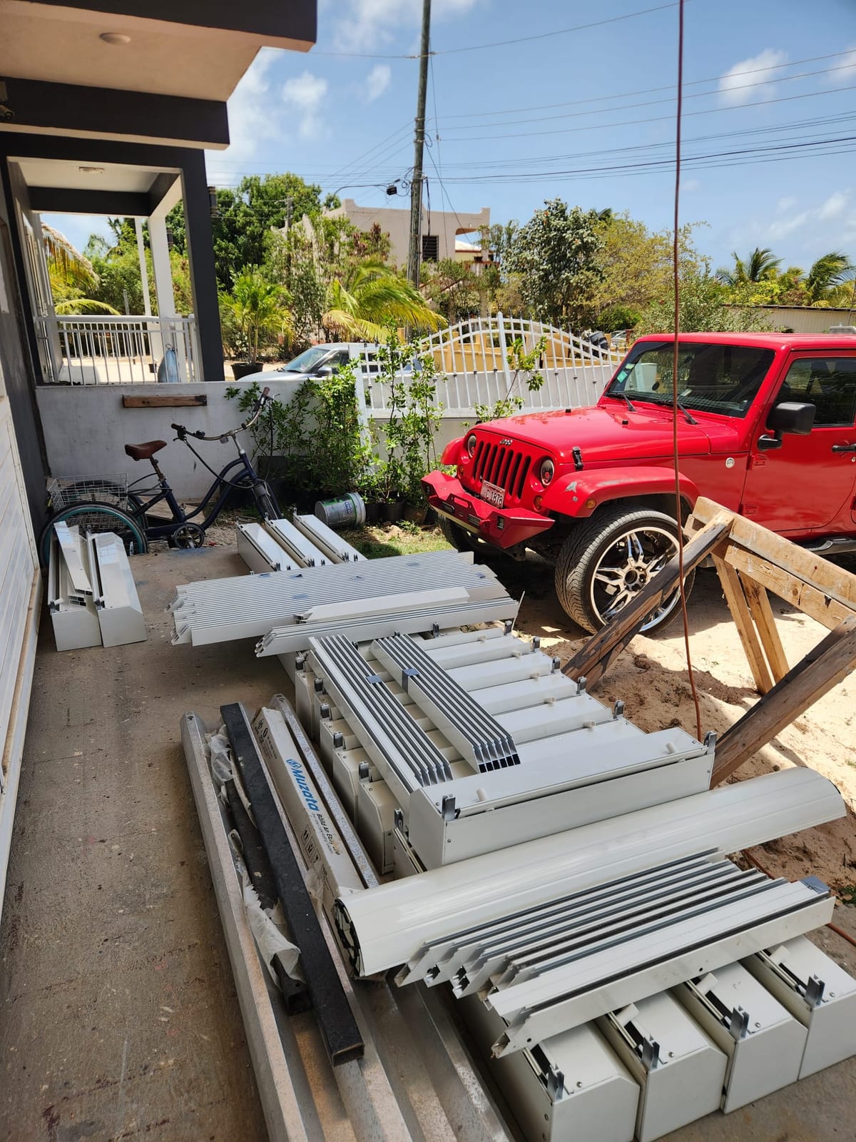 Roller shutter boxes and rails delivered to a job site in Anguilla before installation